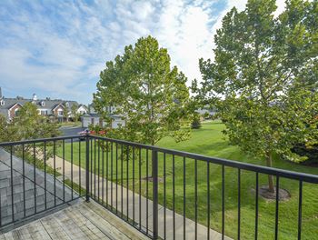 Exterior Balcony Overlooking the Lush Green Grass and Trees